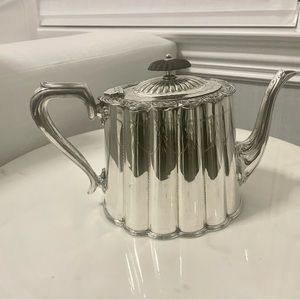 Exquisite British antique silver teapot. Vintage piece with delicate details.